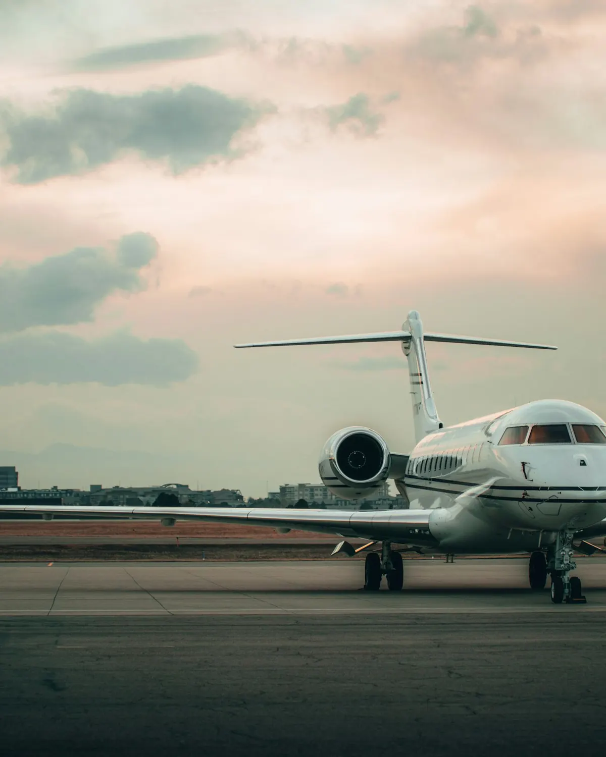 A private jet waiting on the ramp at dusk