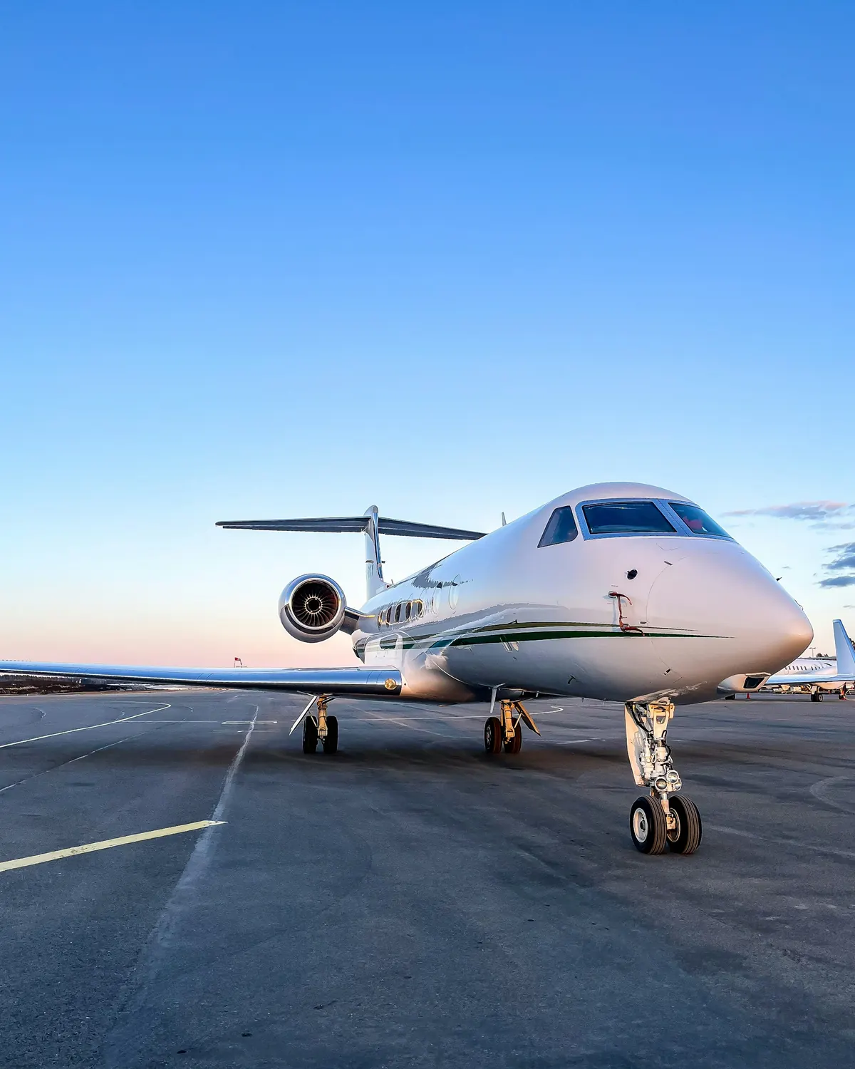 A Gulfstream jet parked under a deep blue sky