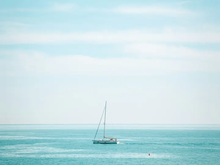 A sailboat on open water off the coast