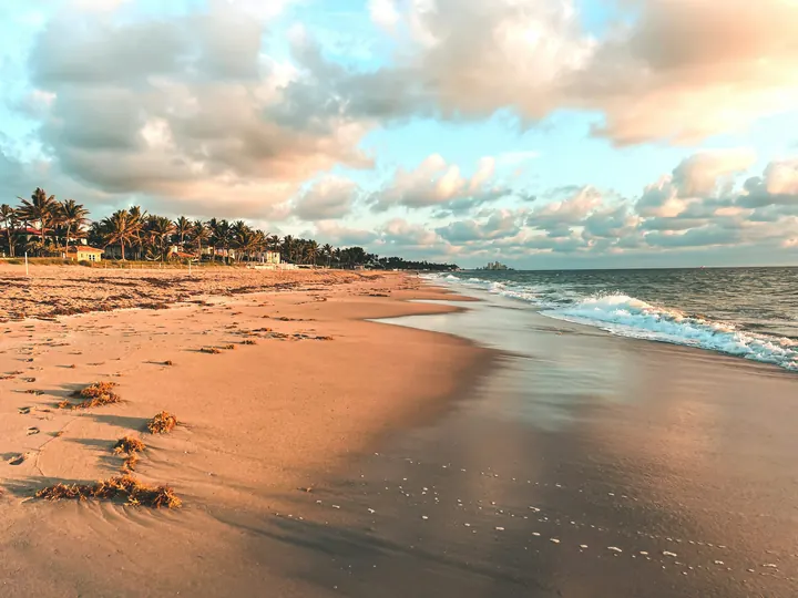 Sand and gentle surf at sunset on an ocean beach