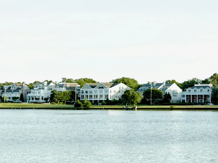 Waterfront houses along a calm East End harbor
