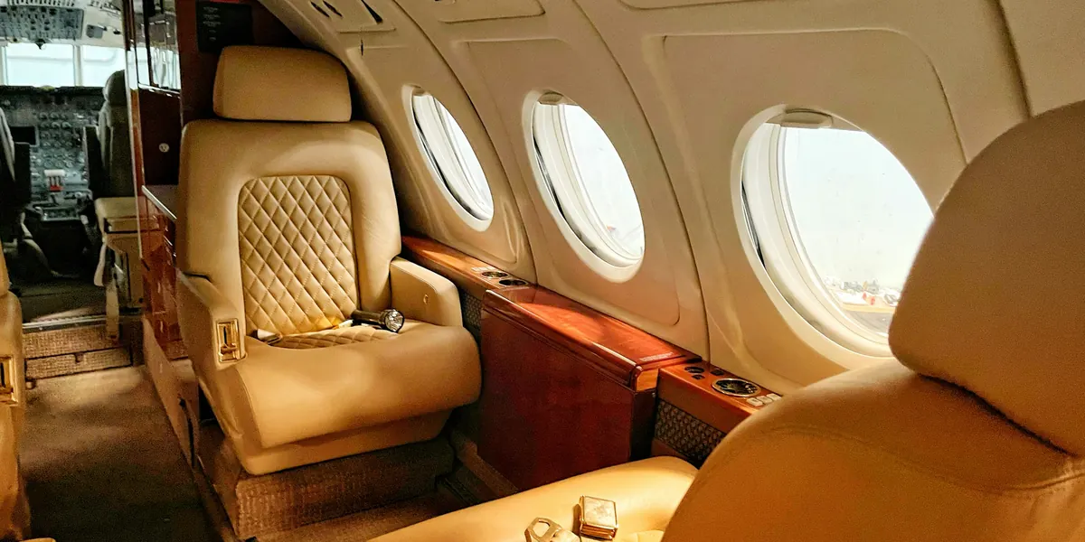 Cream leather seats in a warm-lit private jet cabin